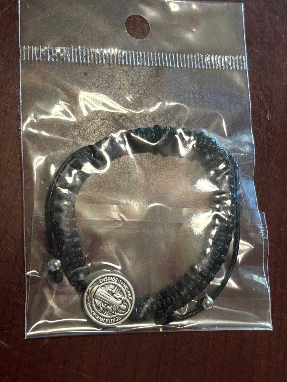 Saint Benedict                      Black Braided Cord Bracelet with Coin Charm
